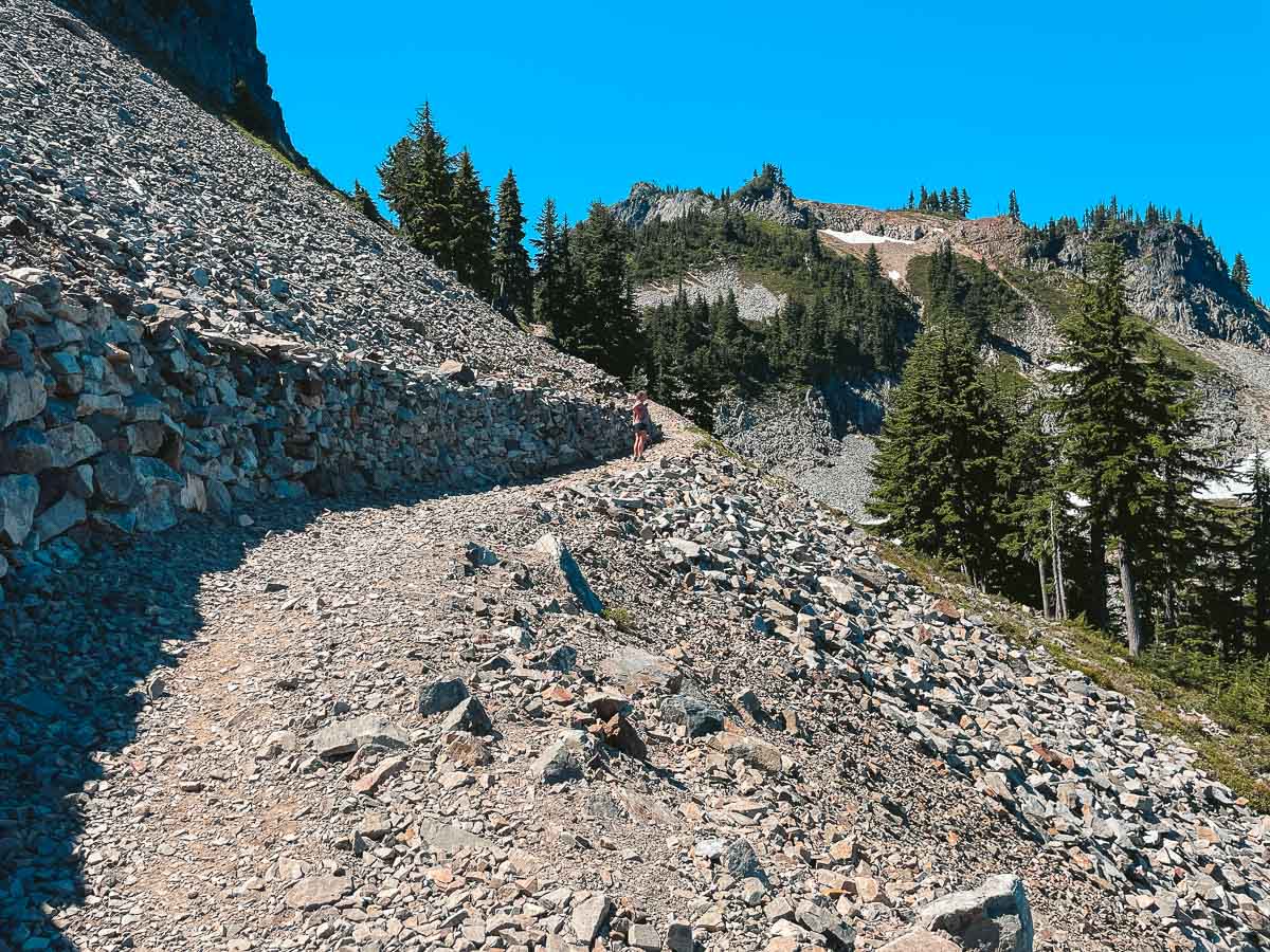 The trail is cut into the side of Pinnacle Peak with medium sized boulders scattered throughout. 