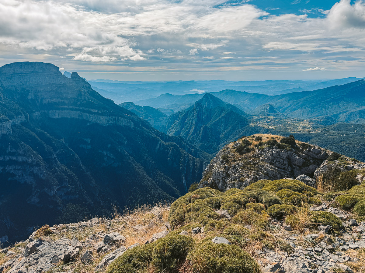 The view point from Pico Mondoto of Ordesa Valley below with green stubbed grass to sit on.
