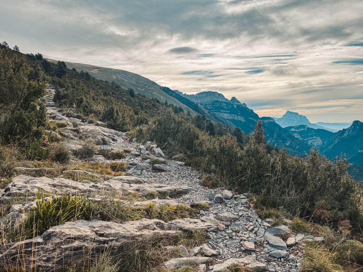 The rocky trail leading up to Pico Mondoto with mountain peaks in the background.