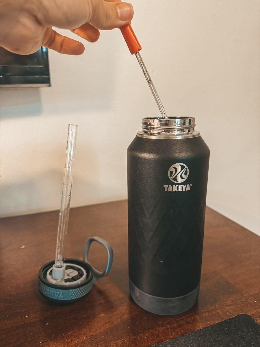 testing the temperature of water for my Takeya water bottle review with a thermometer