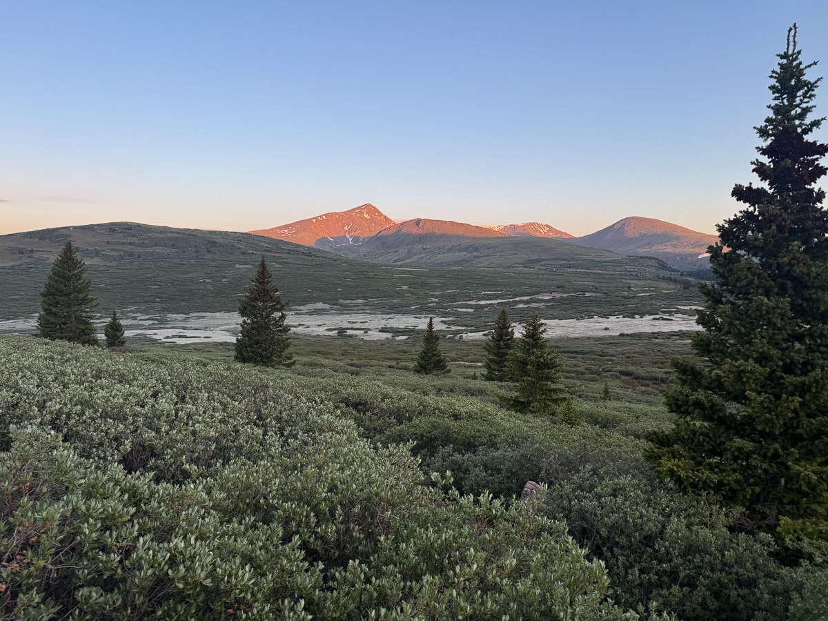 The view behind us on Mount Bierstadt trail with the sun shinning on the mountains. 